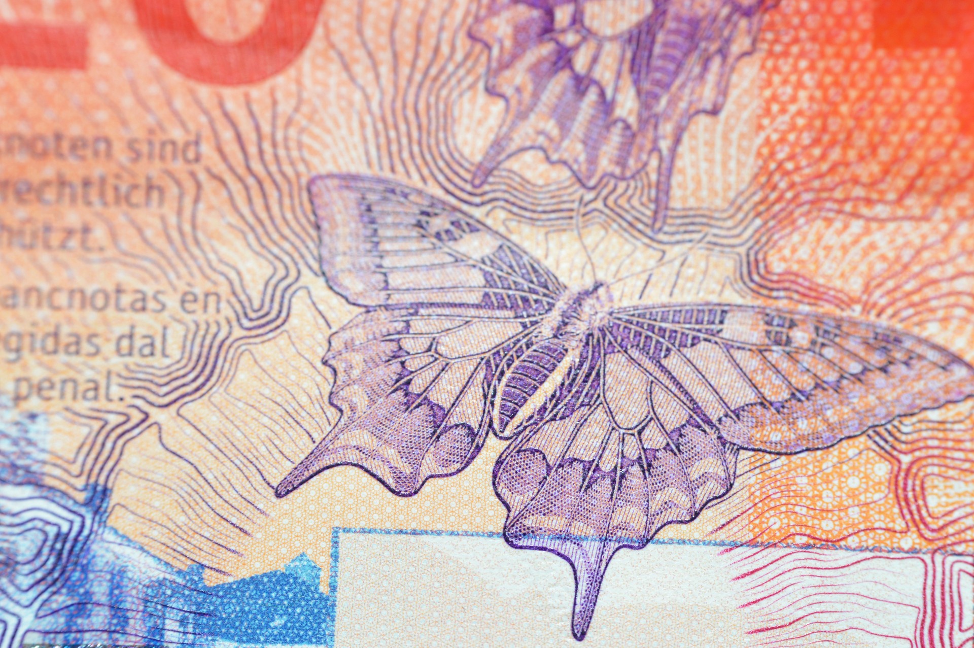 A closeup of Switzerland 20 Twenty Francs, butterflies, a light projected at a screen, human eye iris lines, hand, security stripe, light emissions map of Switzerland
